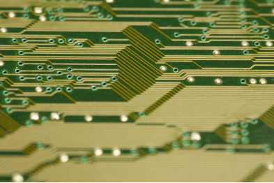 Close-up of high-density copper traces and micro-vias on an ultra-thin PCB showing precision manufacturing.
