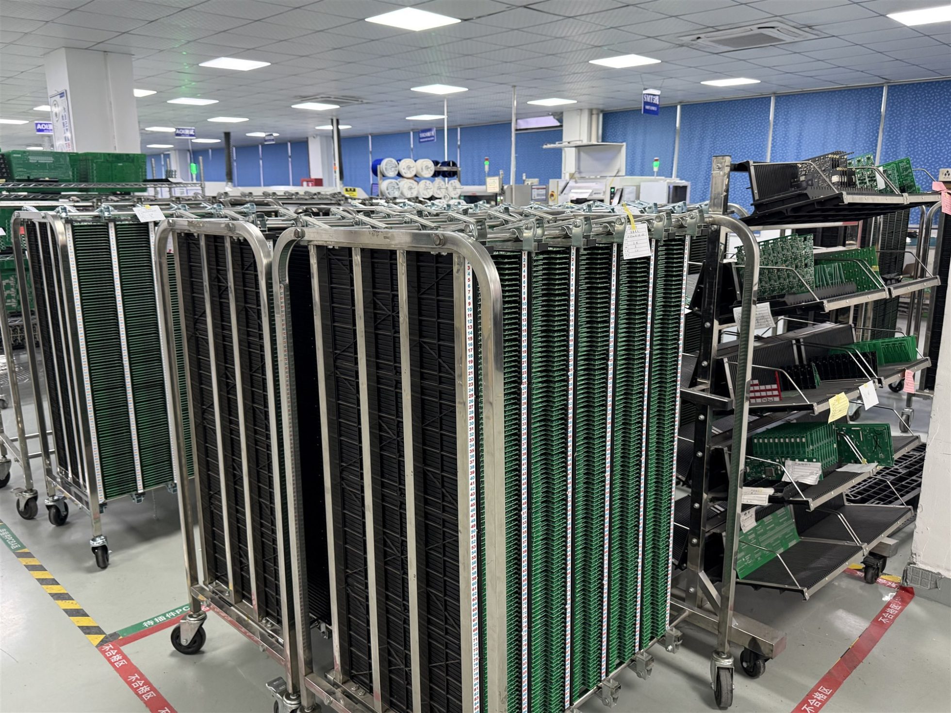 PCB assemblies stored in ESD-safe racks between controlled production steps
