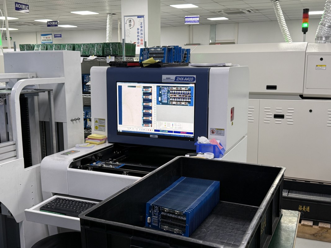 Inspection equipment with a monitor beside racks of circuit boards