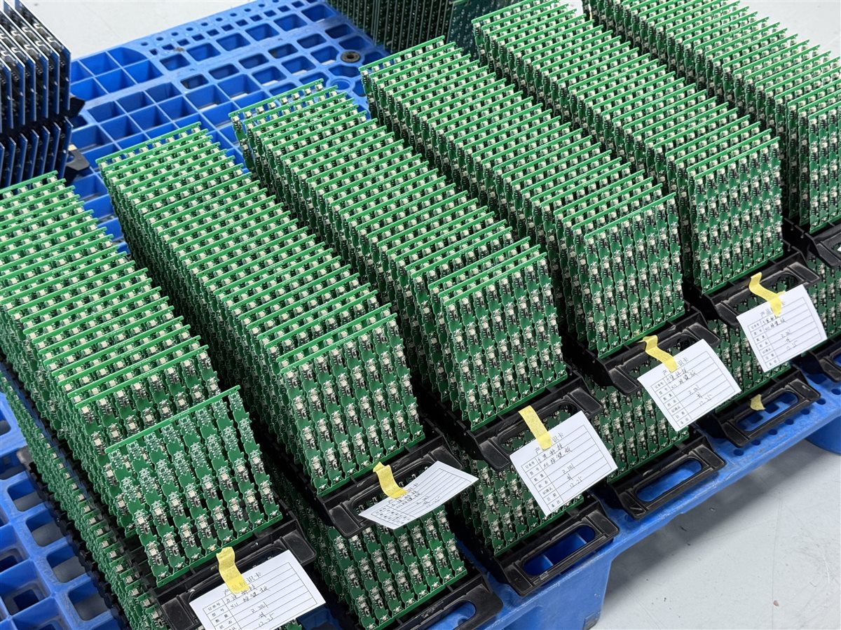 Representative factory photo of PCB assemblies organized in trays before a production release review
