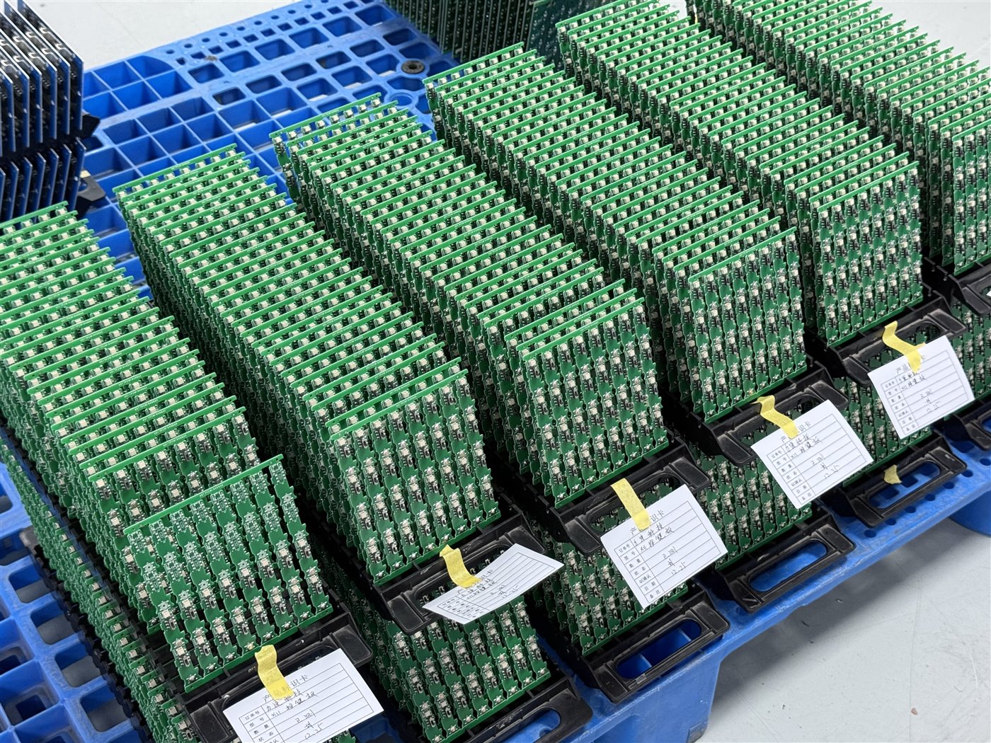 Representative factory photo of separated PCB assemblies in batch trays with identification cards