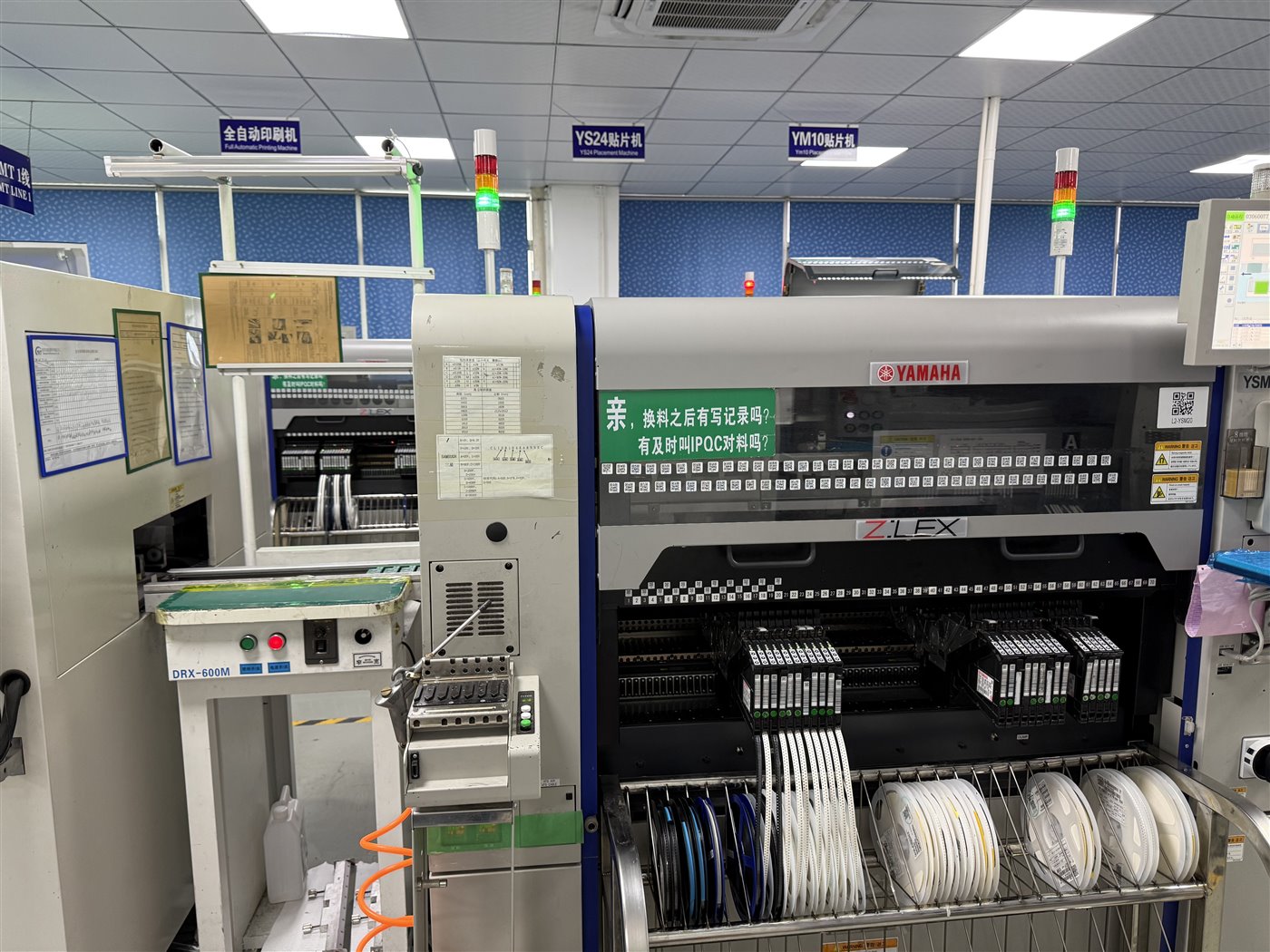 Representative factory photo of SMT feeder setup and component reels used for controlled PCB assembly
