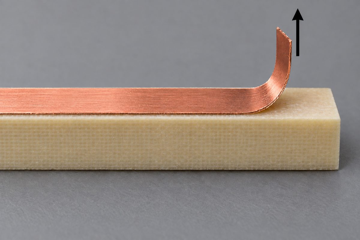Conceptual copper peel strip on a laminate coupon with an upward-force arrow