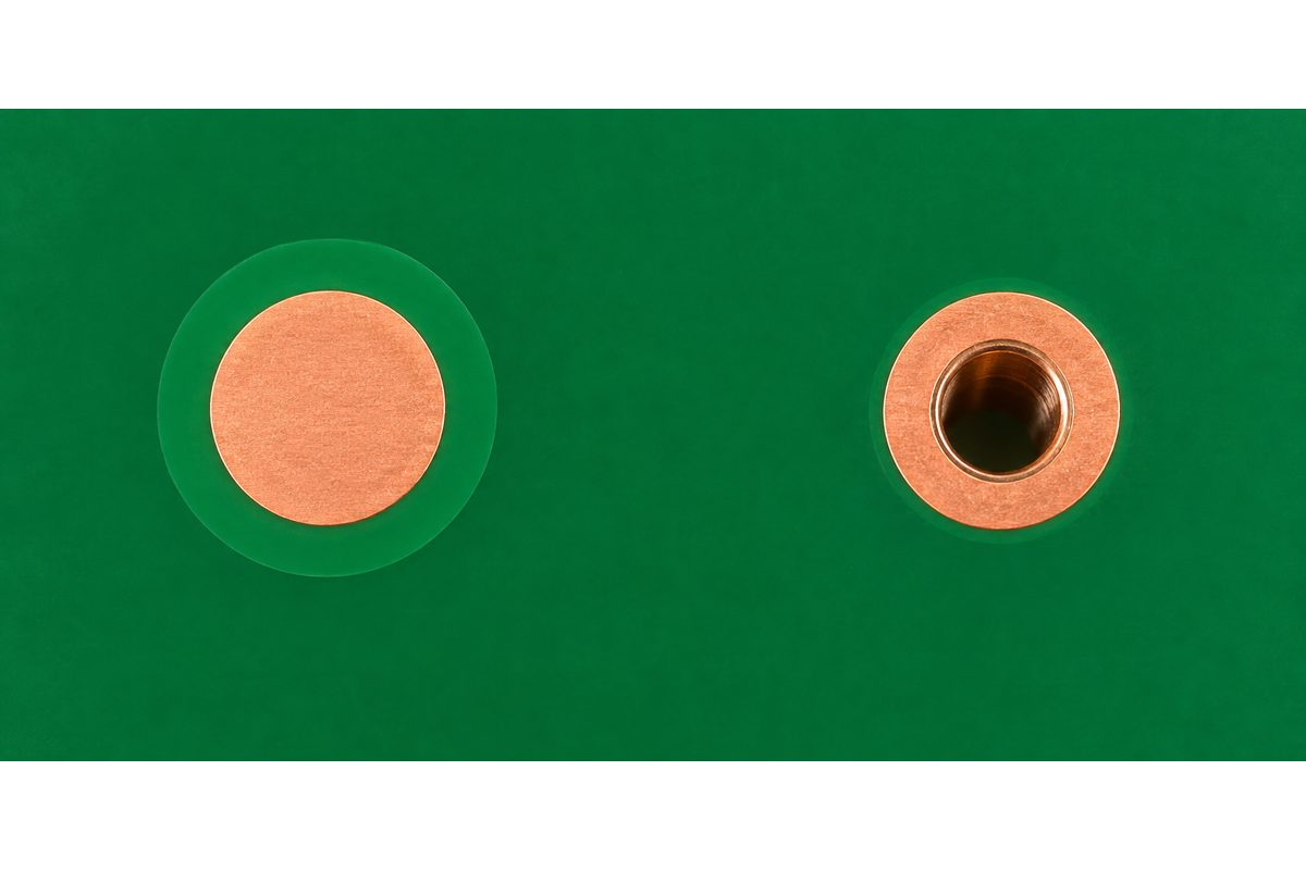Conceptual comparison of a solid copper fiducial target and a plated hole with an annular ring