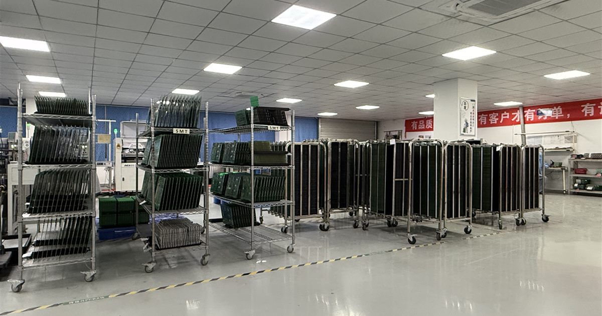 Circuit boards staged in racks at a PCB assembly facility
