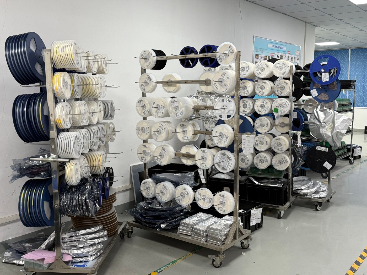 Component reels on mobile racks in the factory material area