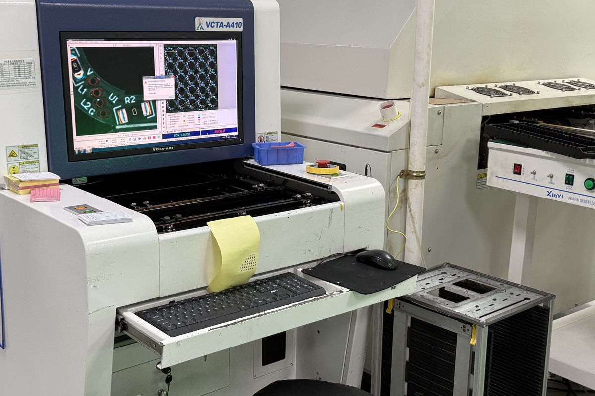 Factory optical inspection equipment with a circuit-board image displayed on its monitor