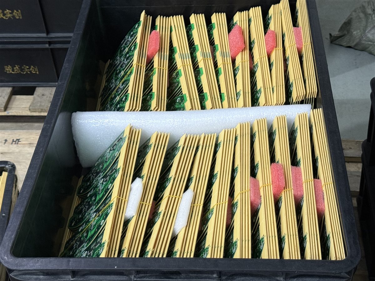 Representative factory PCB assemblies staged in protective racks; not evidence of embedded passives