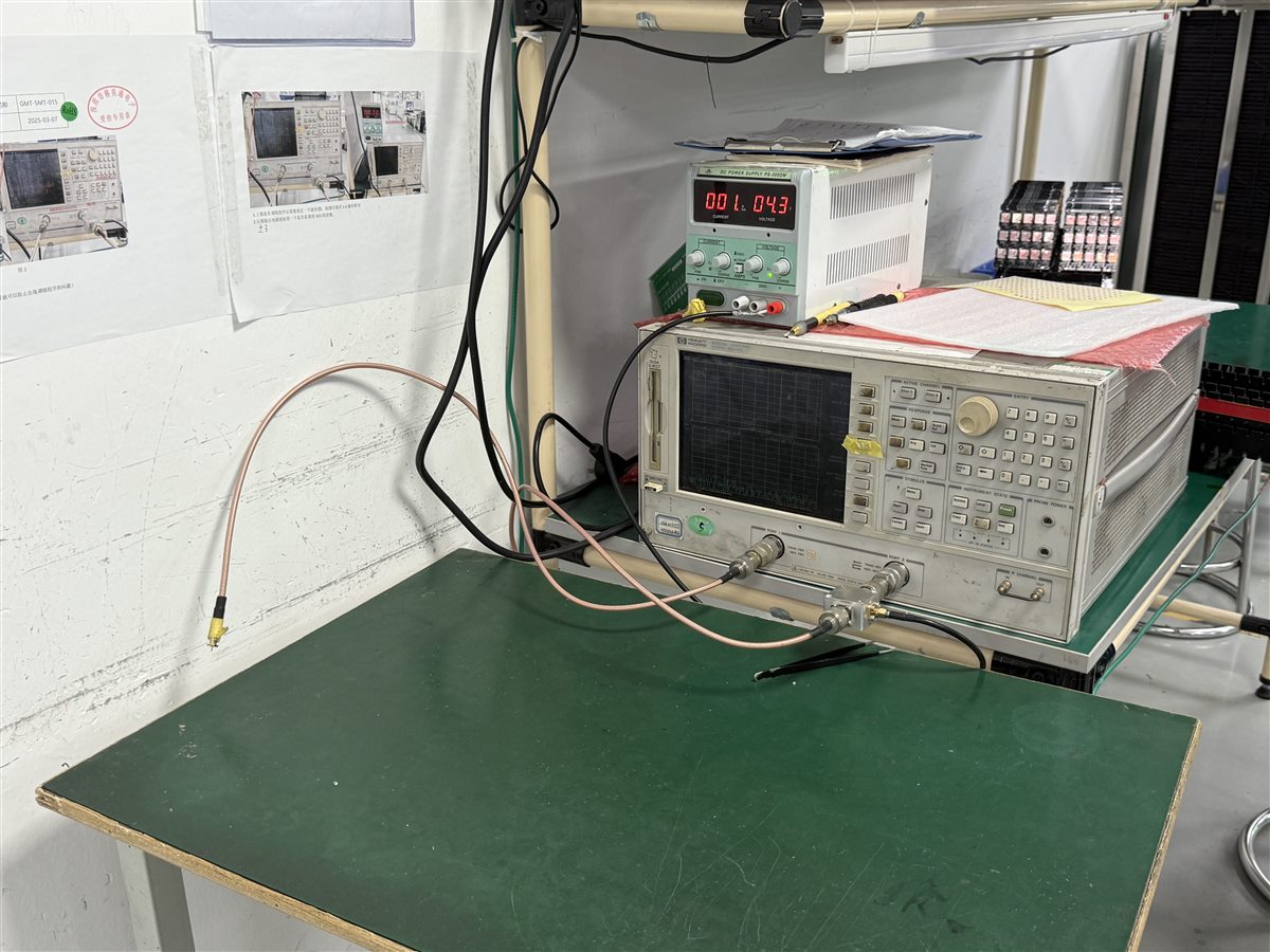 Real factory electronics test bench with instruments; not a labeling machine timing qualification setup