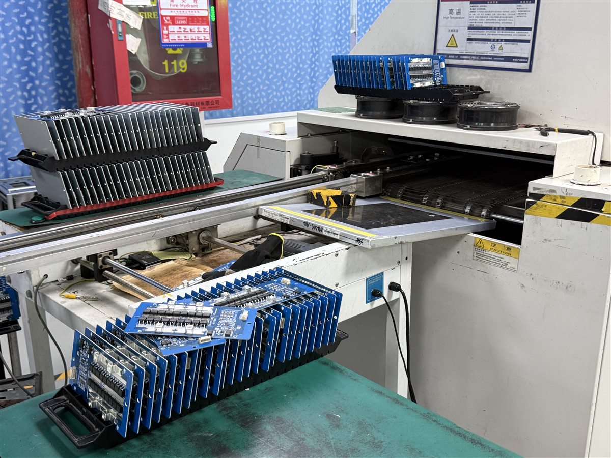 Representative assembled PCBs in factory production; not identified as labeling machine controllers
