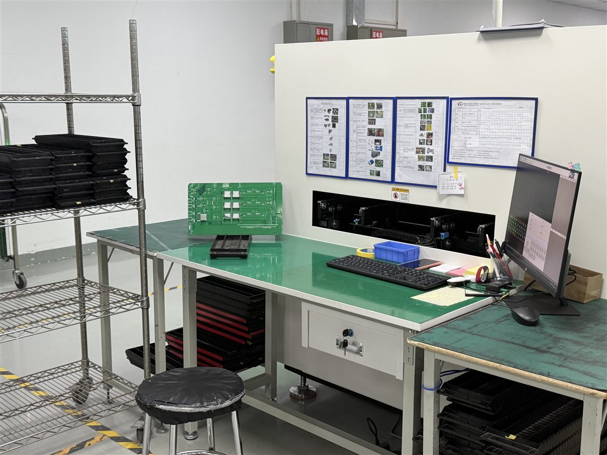Real factory PCB inspection station with circuit boards and inspection monitor; not an ELIC microvia qualification record